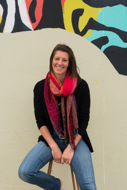 Amy-B-Local-Label-Digital-Agency.webp Amy Brandon on a stool in front of a colourful zebra mural in local Fremantle